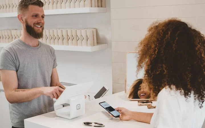 Customer paying by phone at a counter